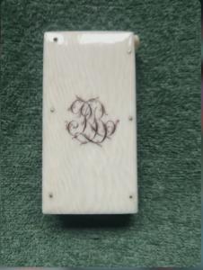 Caja de cerillas de marfil con iniciales grabadas.
    