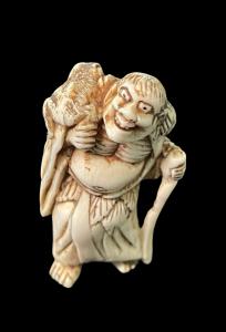 Netsuke de marfil que representa a un personaje masculino. Japón.